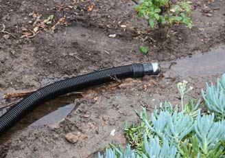 water ends up accumulating at the base of the downspout